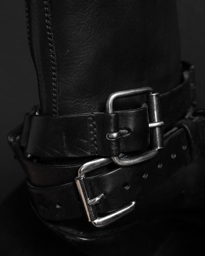 Ann Demeulemeester black leather belt buckle boots. Close up view on buckles.