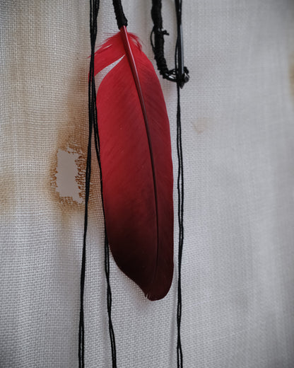 Detail image of Ann Demeulemeester SS2017 runway necklace with black beads and red feather detail