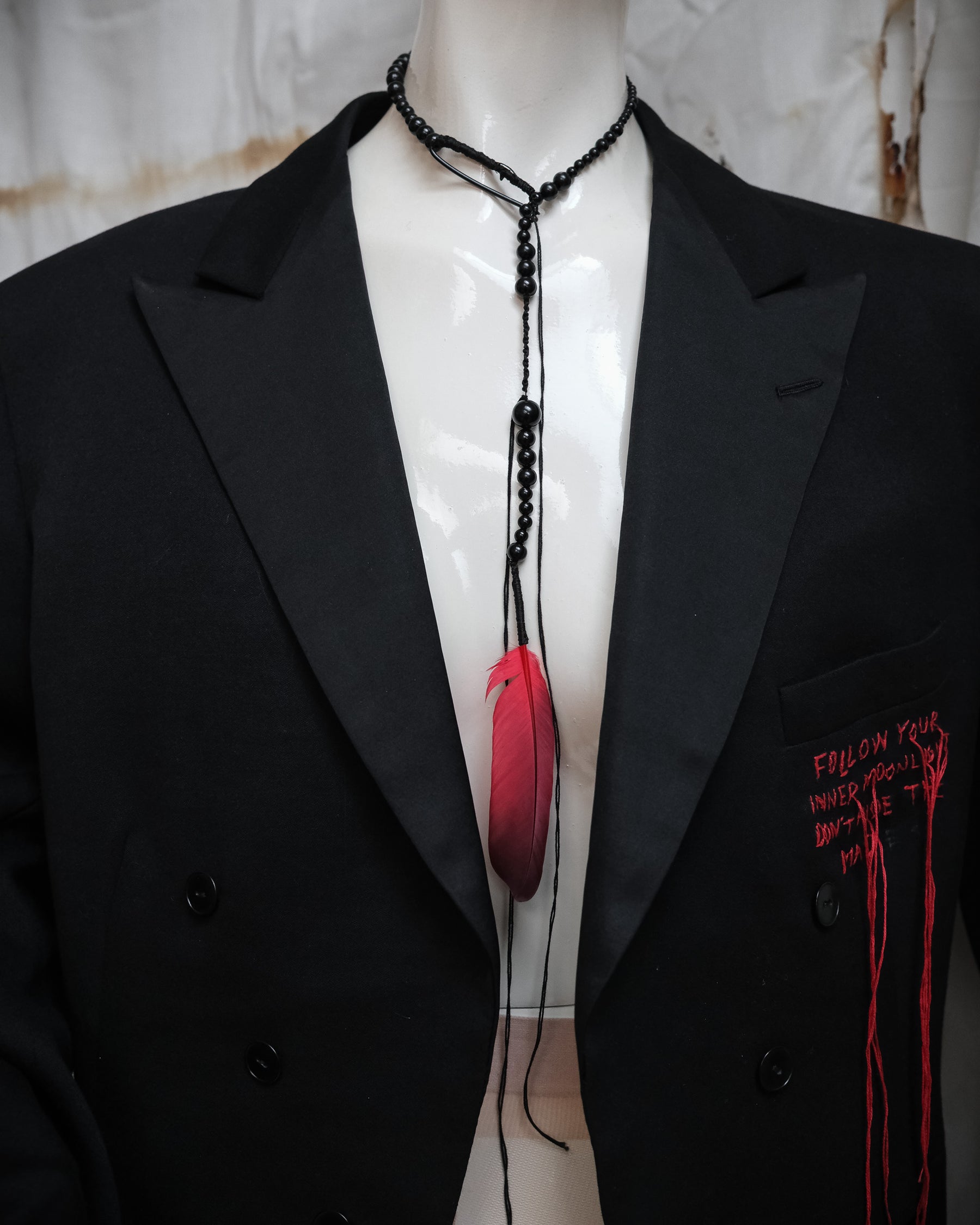 Ann Demeulemeester SS2017 runway necklace with black beads and red feather detail